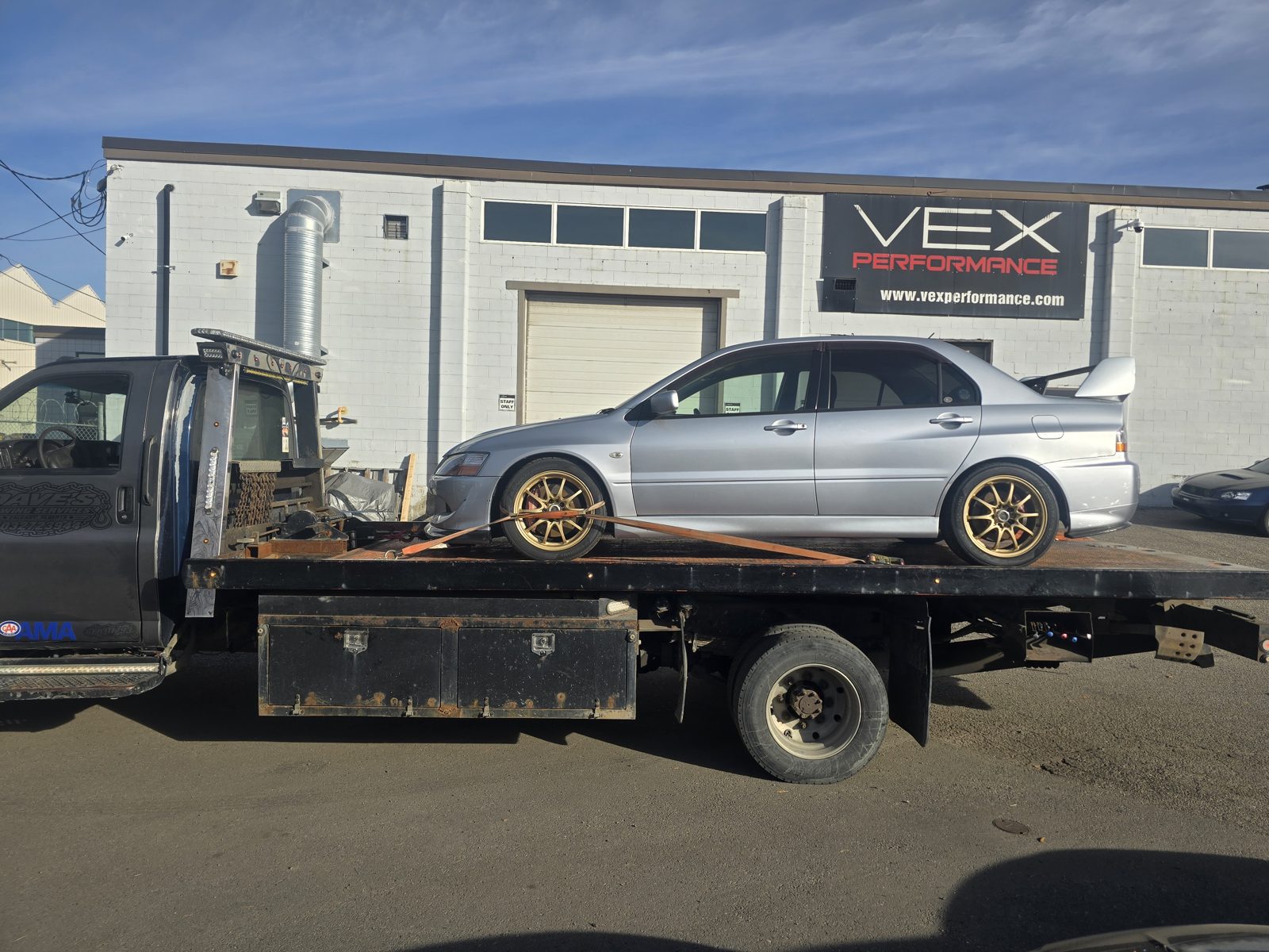 Dave's Towing: Silver Mitsubishi Lancer Evolution Flatbed Tow in Calgary