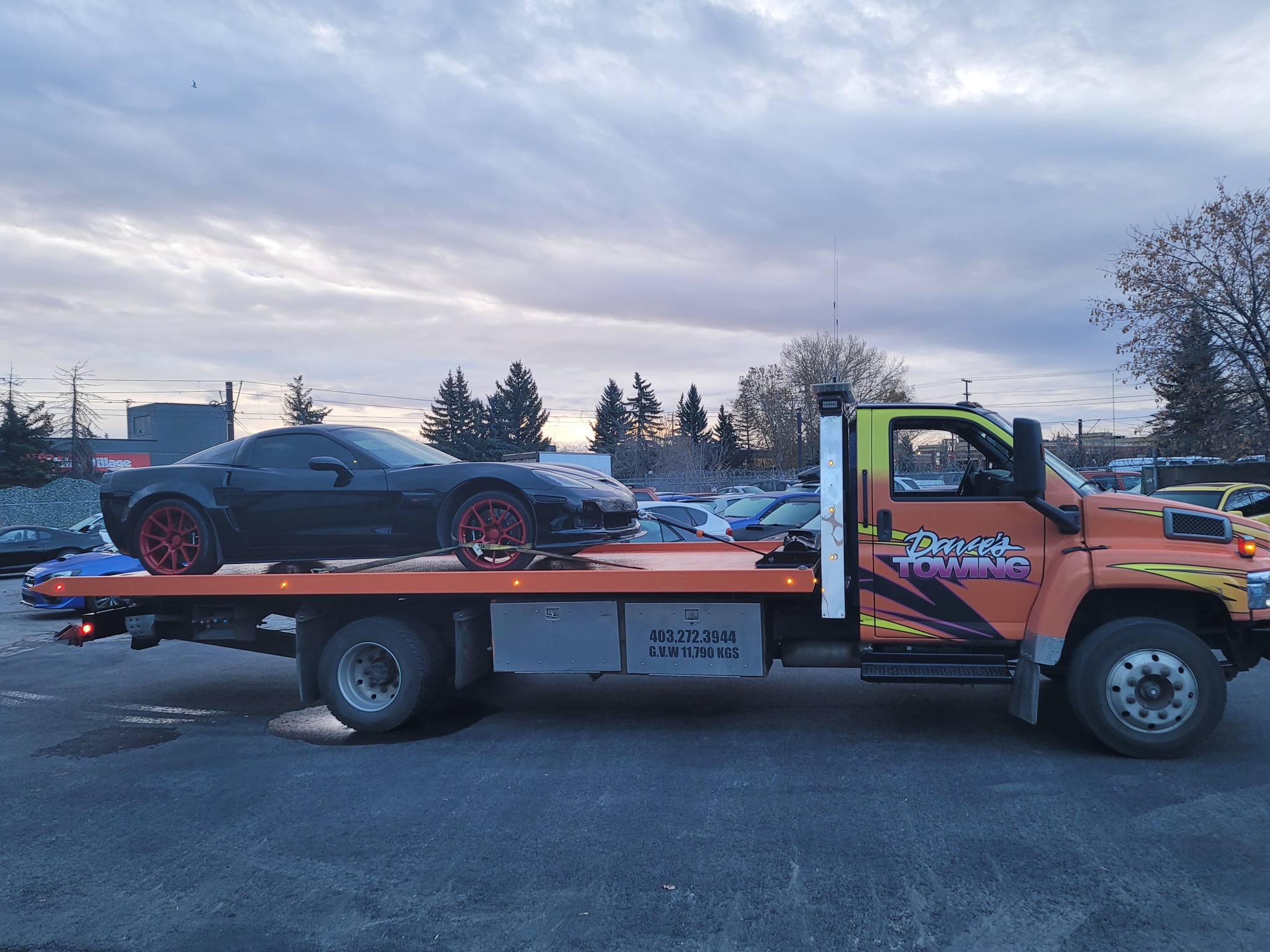 Flatbed towing a classic truck in Calgary