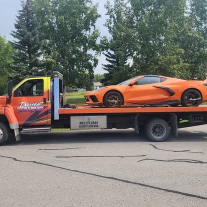 Dave's Towing flatbed truck towing a sports car in Calgary
