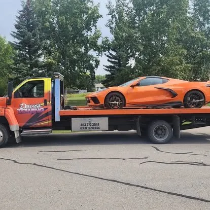 Dave's Towing flatbed truck towing a sports car in Calgary